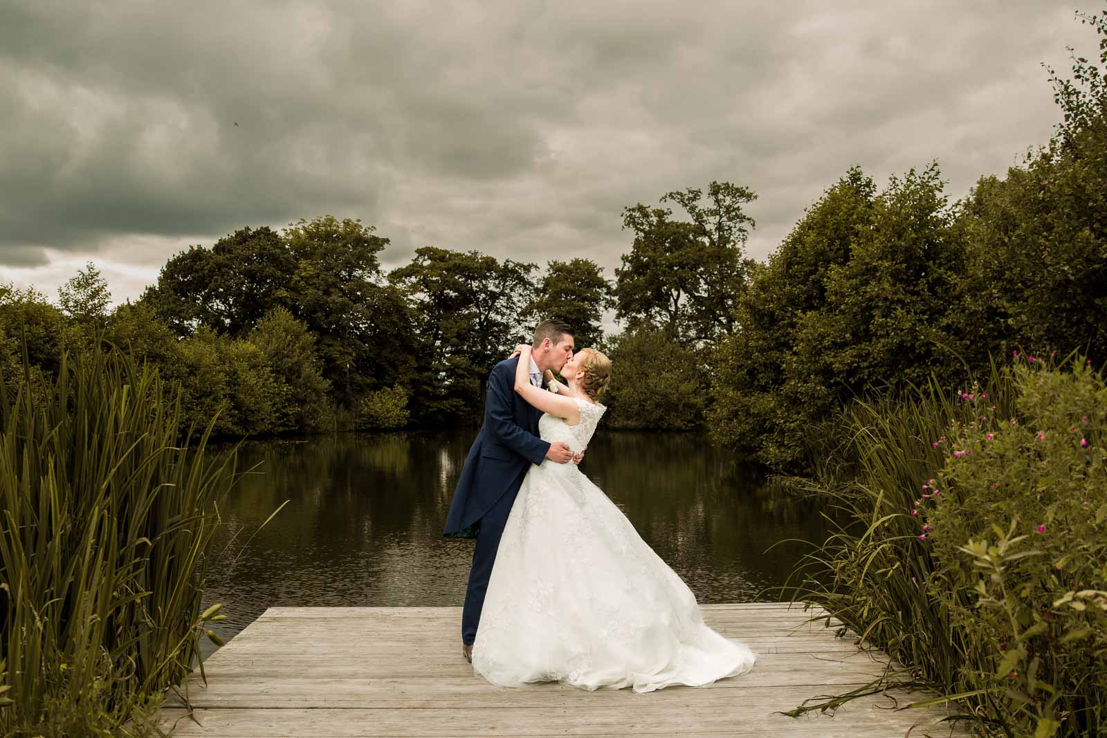 Bride and groom at the lake at styal lodge wedding venue