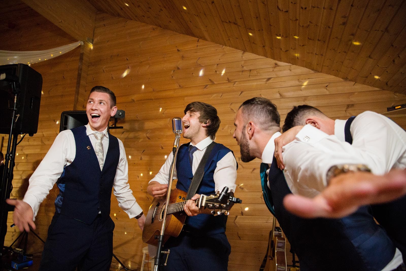 groomsmen singing during the reception at styal lodge wedding venue