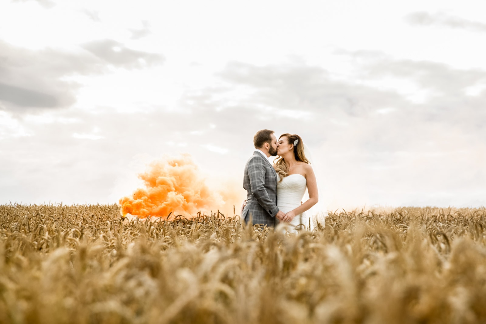 bride and groom in the fields at sandhole oak barn