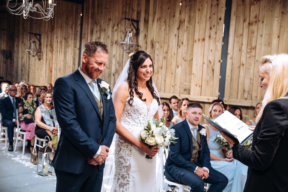 dove barn wedding ceremony with bride and groom