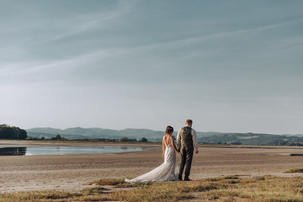 Bride and groom portraits on the beach in the lake district