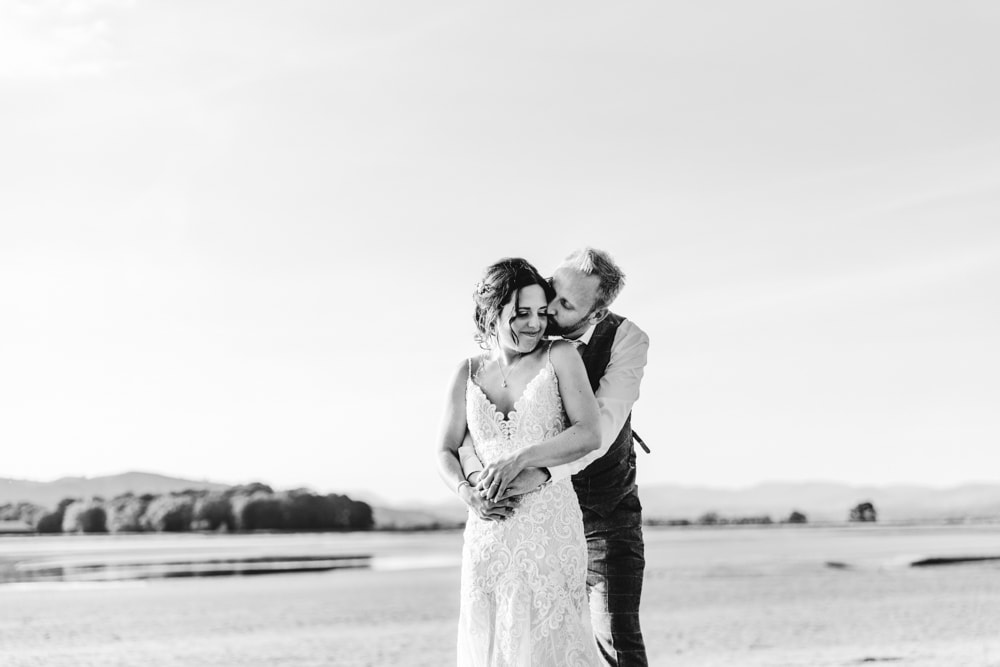 Bride and groom portraits on the beach in the lake district