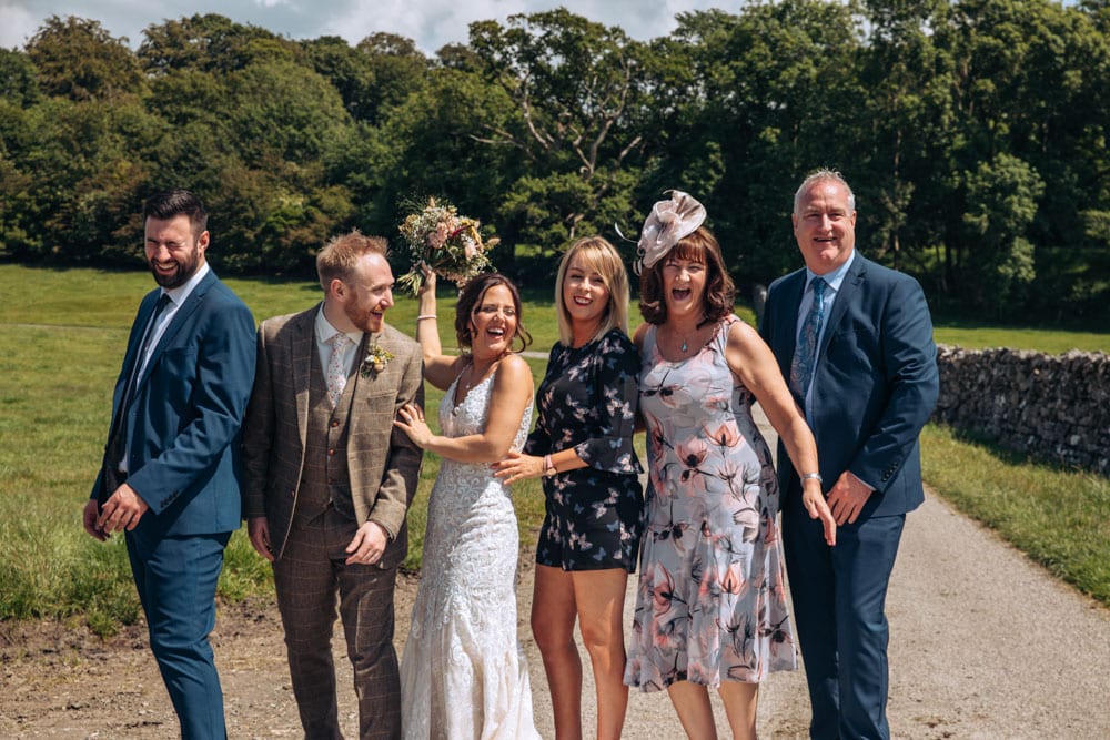 group wedding photos of bride and groom and wedding guests at park house farm