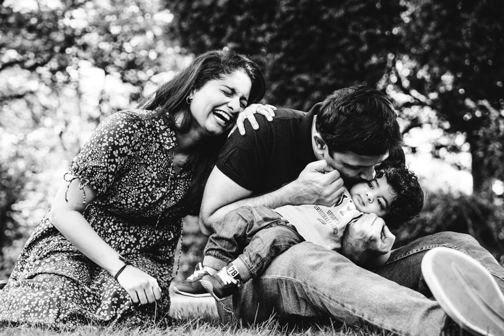 family having a giggle at their family photoshoot in hyde park stockport