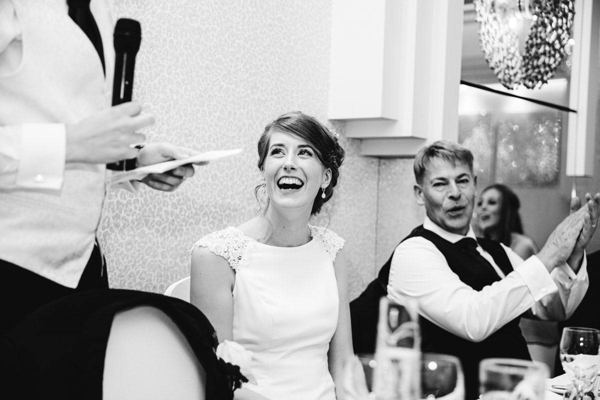 bride giggles during speeches