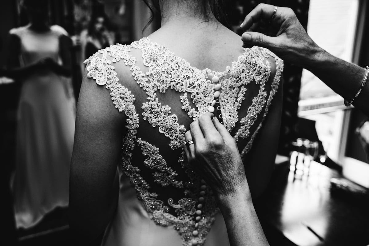 bride getting in wedding dress at thornton hall hotel