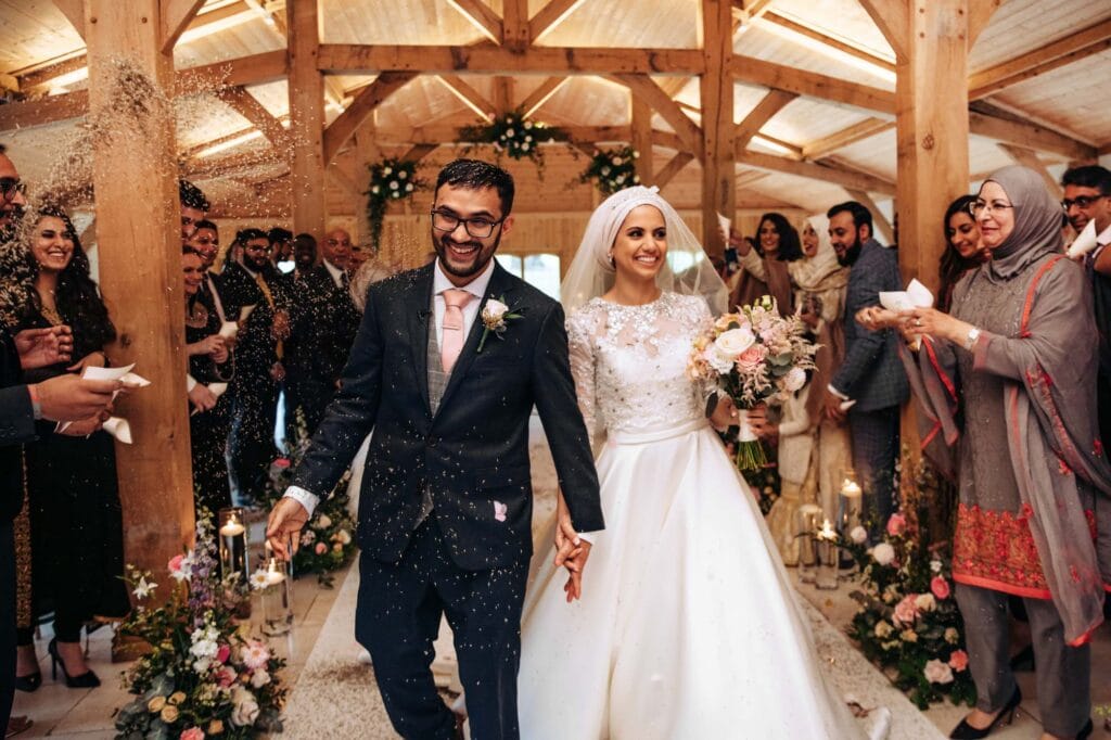 Colshaw Hall Bride and Groom walking down the aisle to confetti