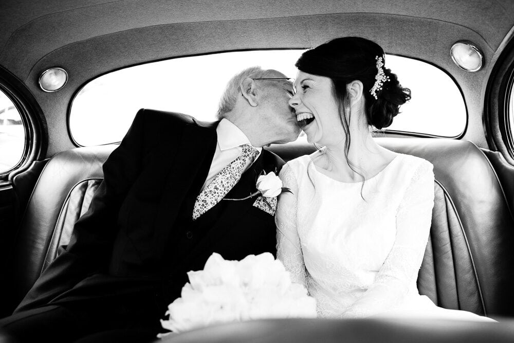 bride and her dad in the wedding car