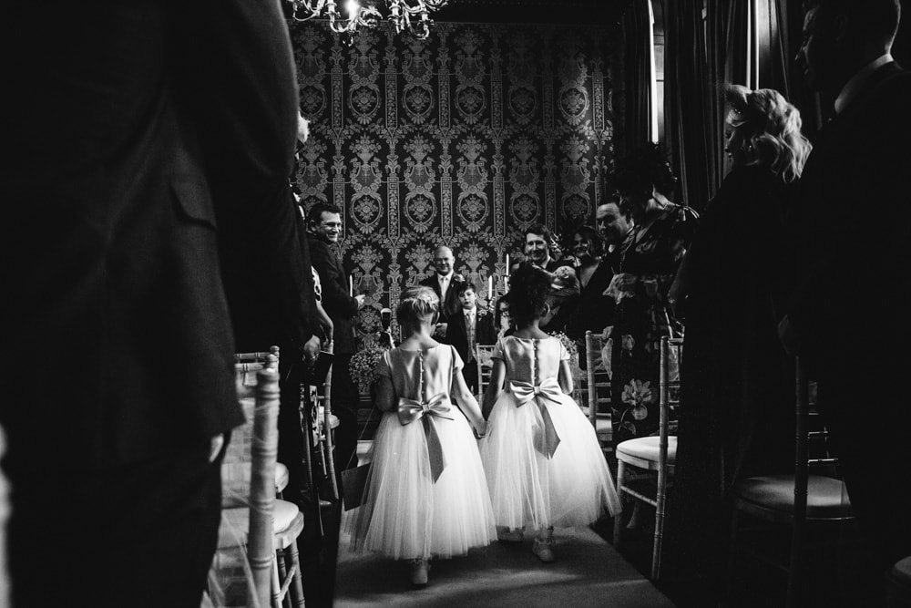 flower girls walking down the aisle at soughton hall