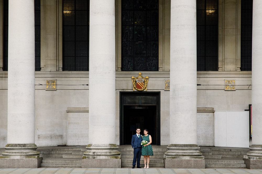 bride and groom outside manchester library
