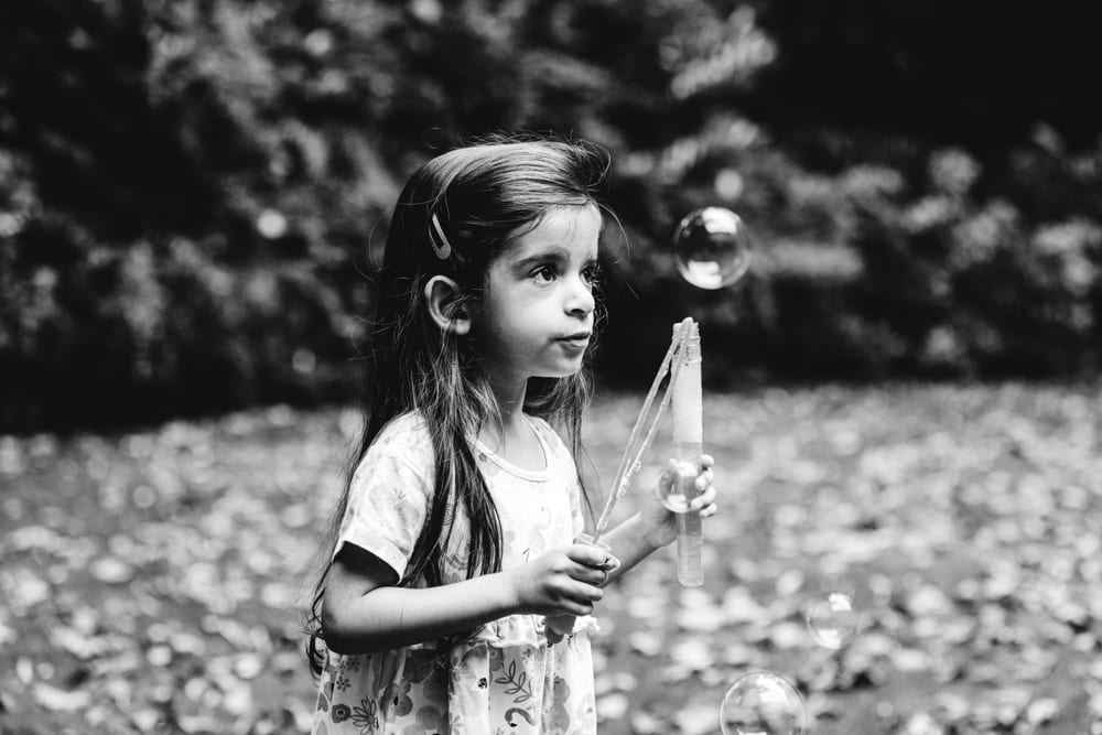 nerea playing with bubbles in her worsley garden