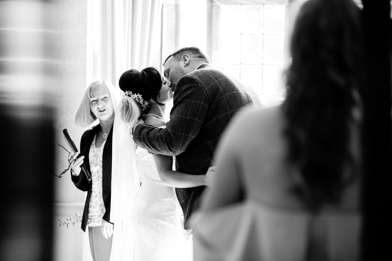 bride and groom kiss during ceremony