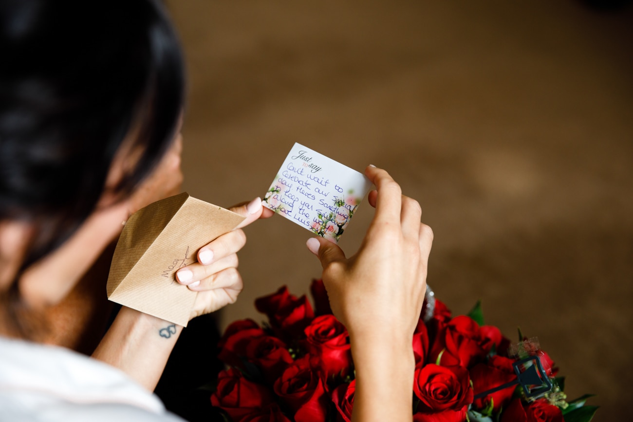 bride reading a card from husband to be