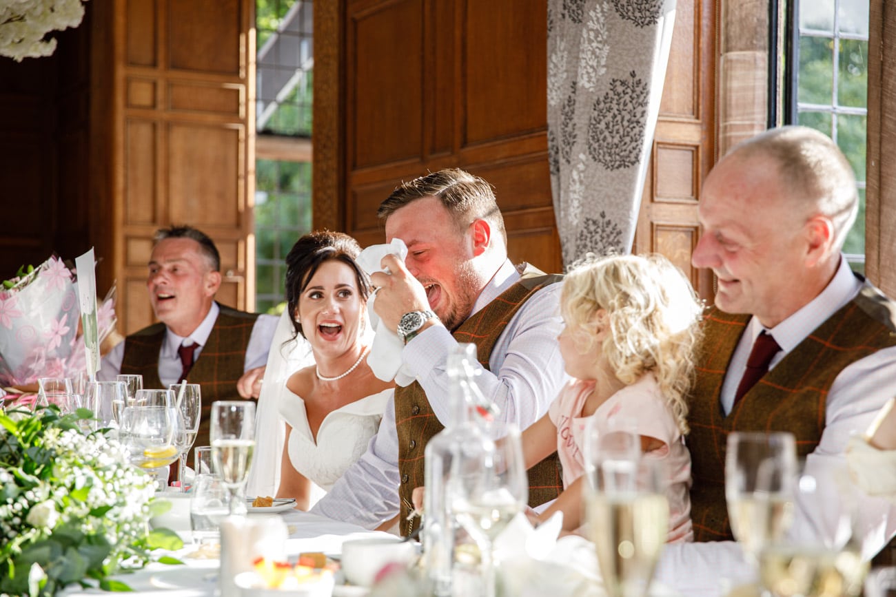 groom laughing during wedding breakfast