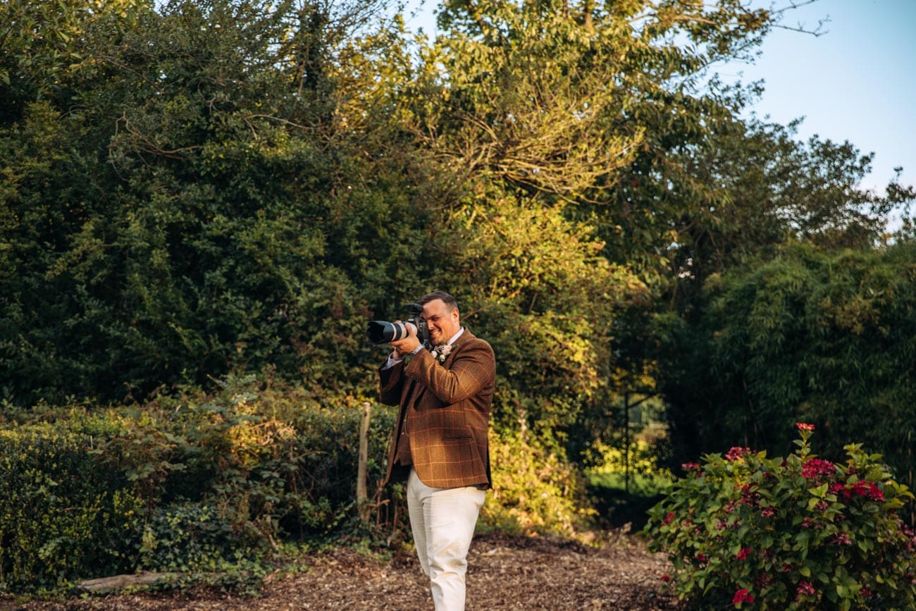groom taking photo of bride at inglewood manor