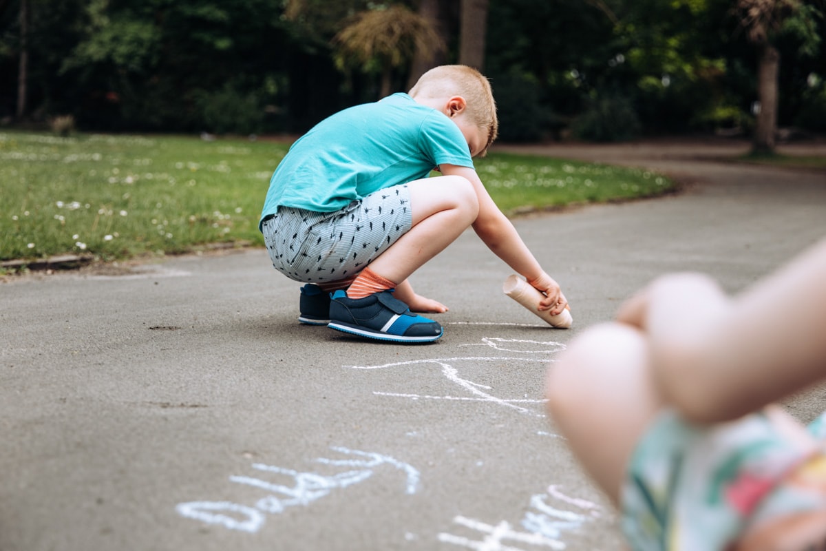 Boy drawing with chalk