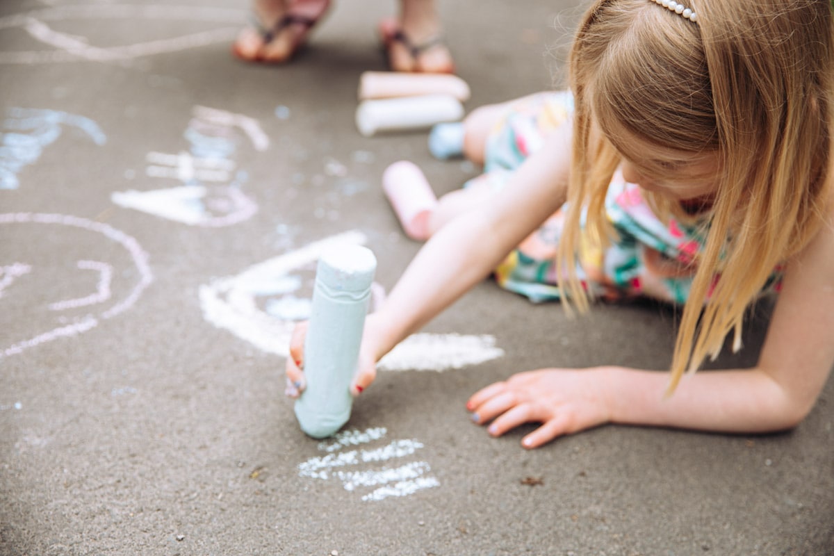 Girl drawing with chalk