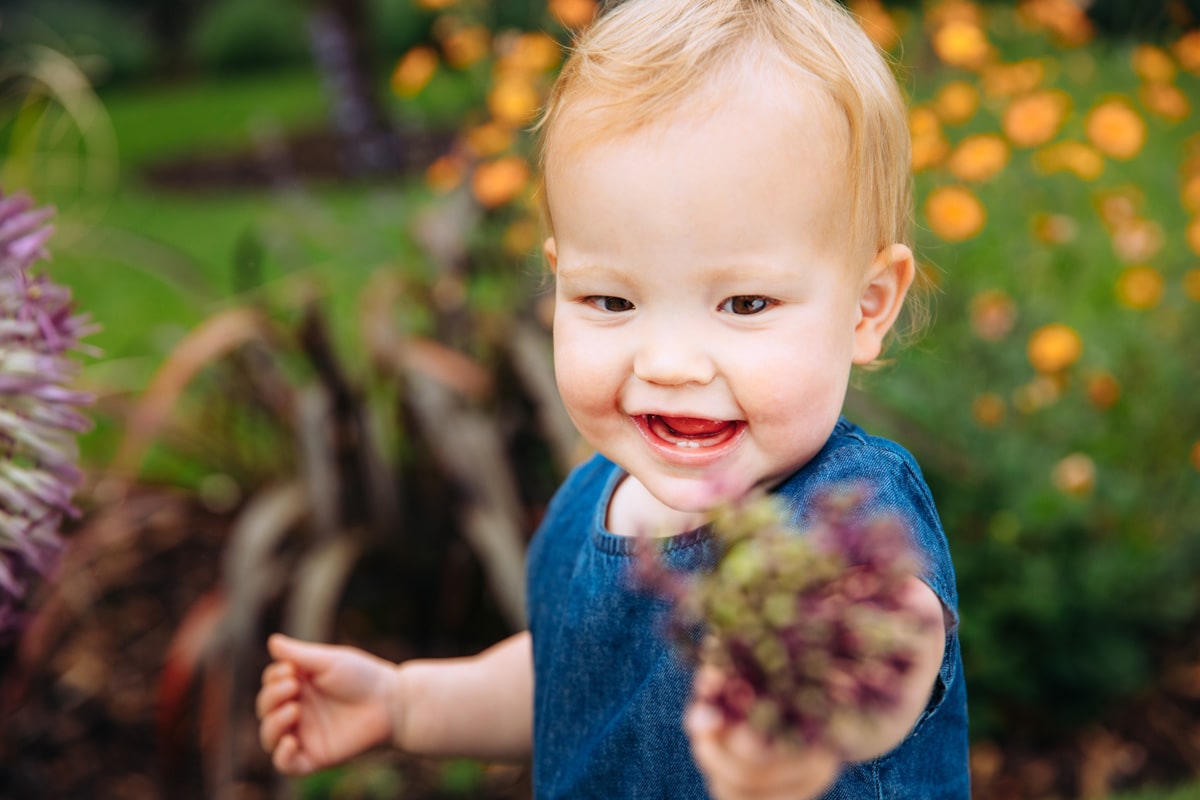 Baby holding flower