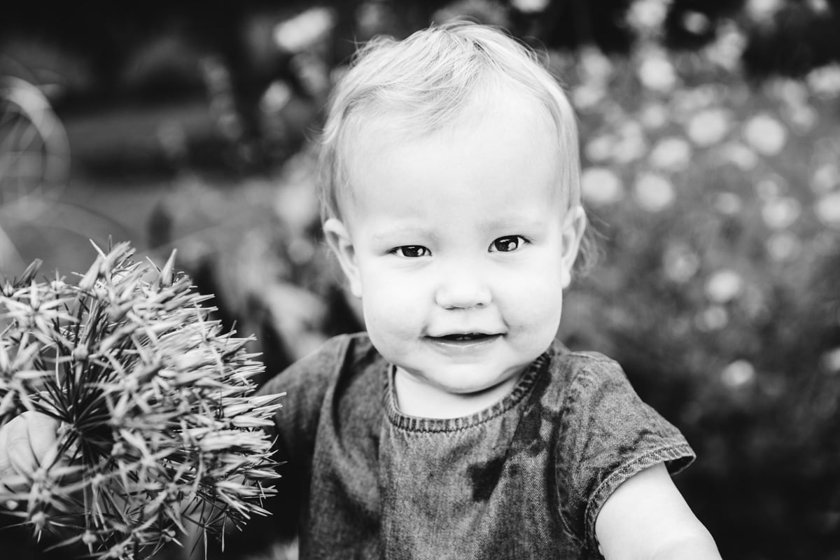Baby holding flower