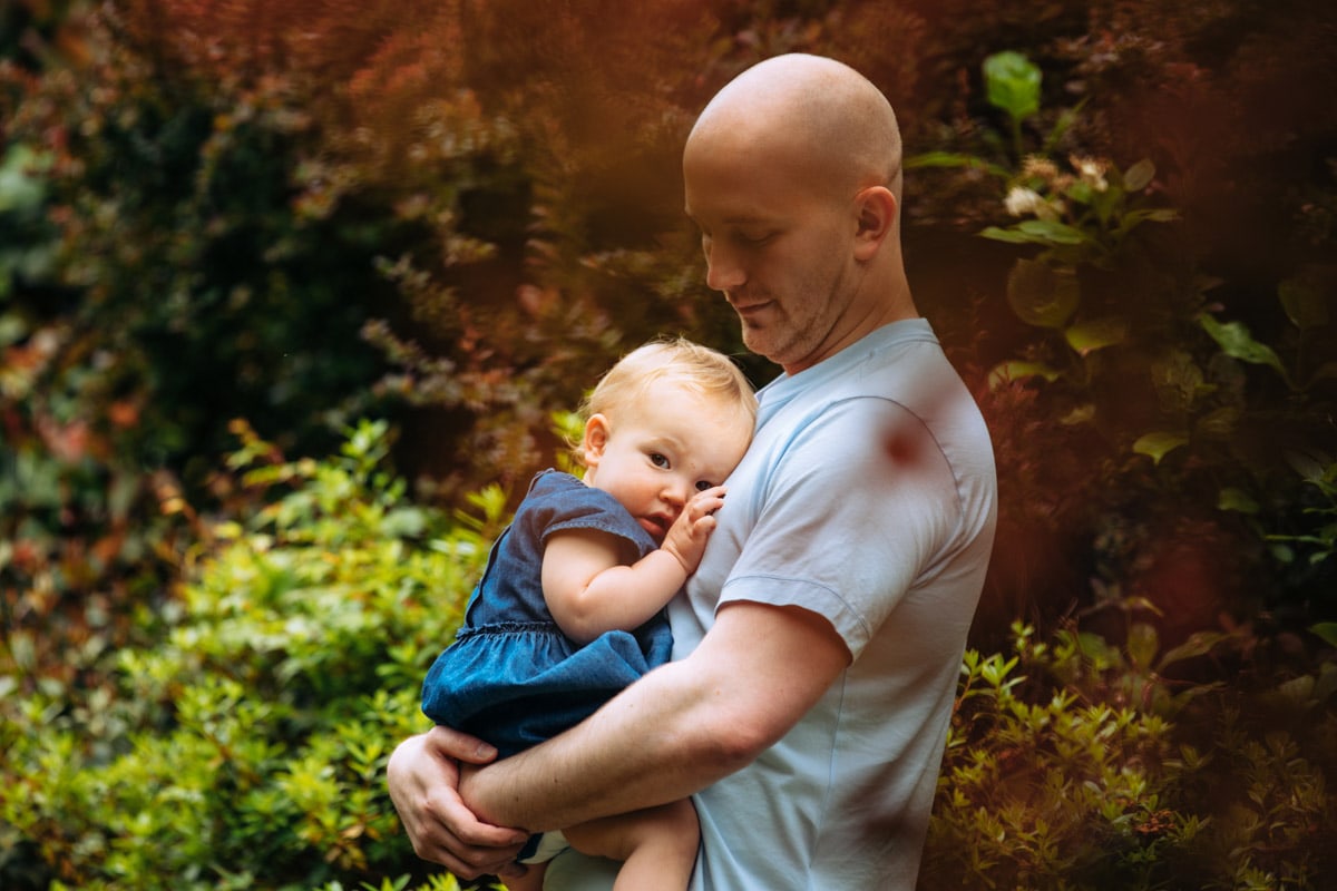 Dad cuddles daughter