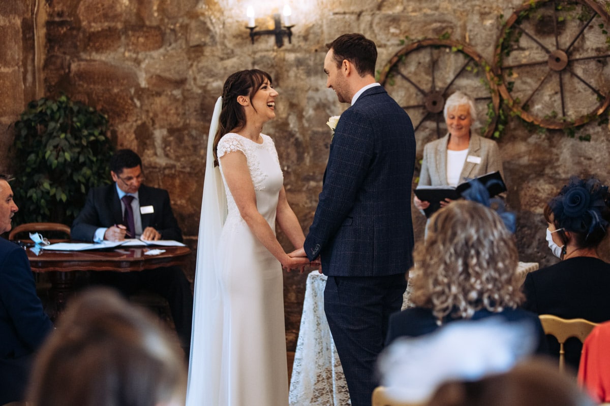bride and groom during the wedding ceremony at danby castle
