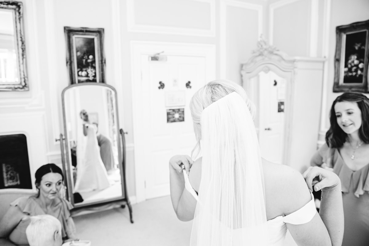 eshott hall bride looking in the mirror