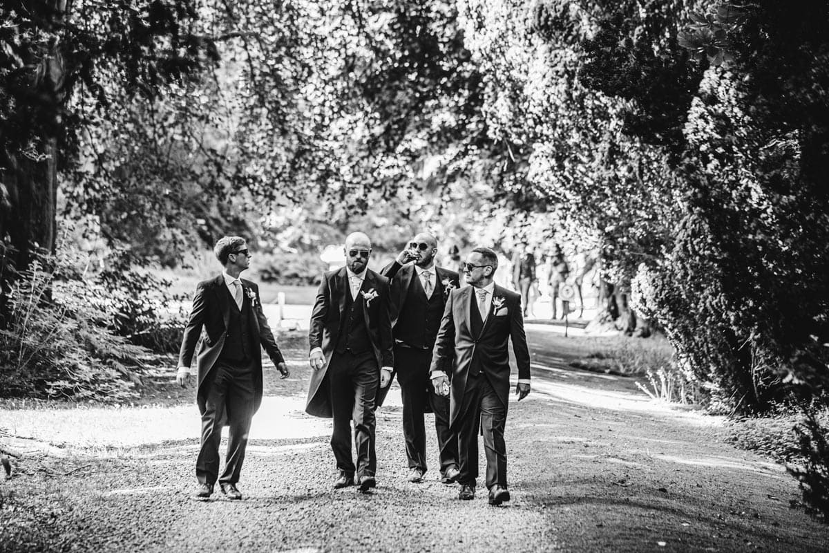 groomsmen walking to the chapel at eshott hall