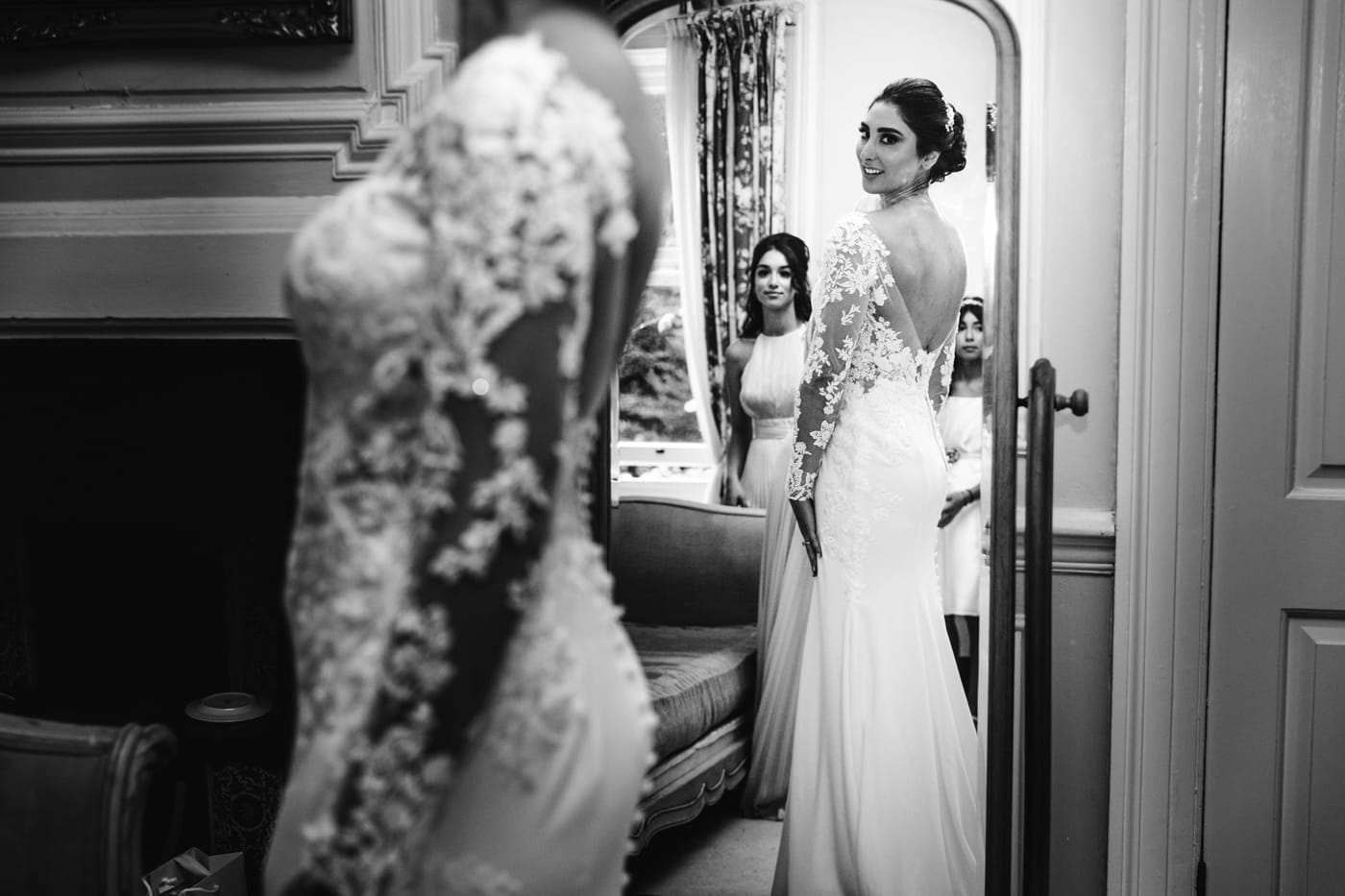 bride getting ready in the mirror at eshott hall