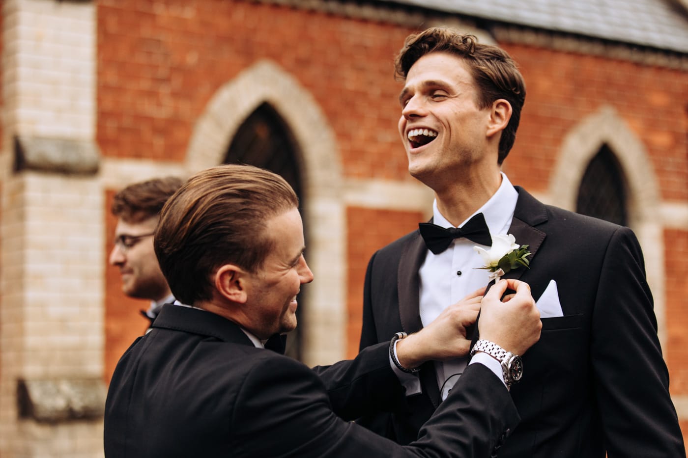 groom getting his flower pinned at eshott hall