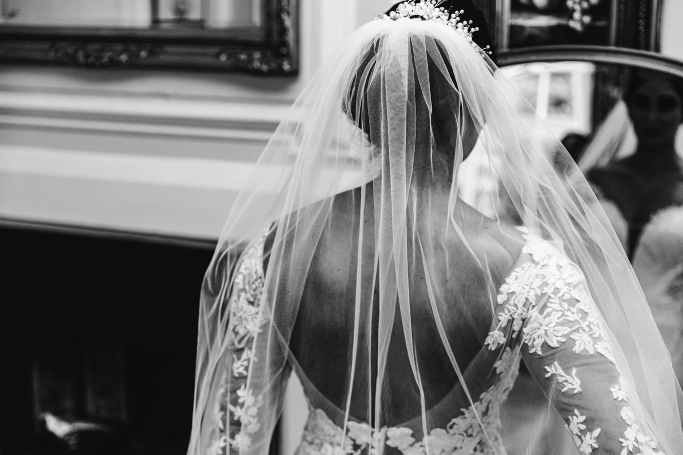 bride having her veil pinned
