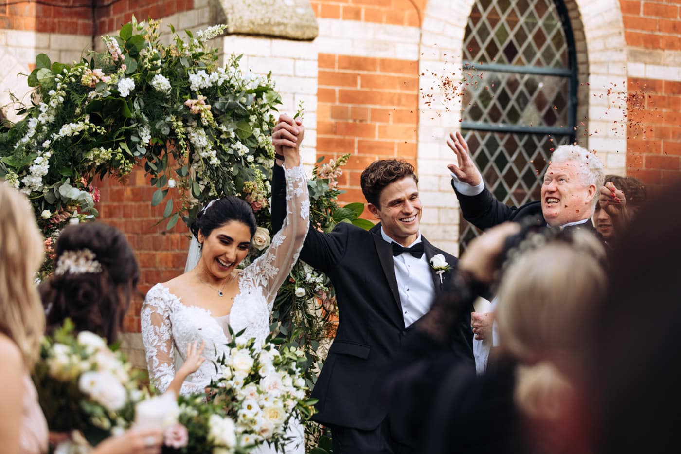 confetti outside the chapel at eshott hall wedding photography