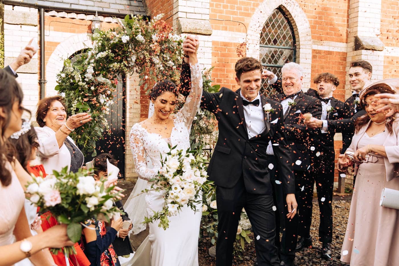 confetti outside the chapel at eshott hall wedding photography