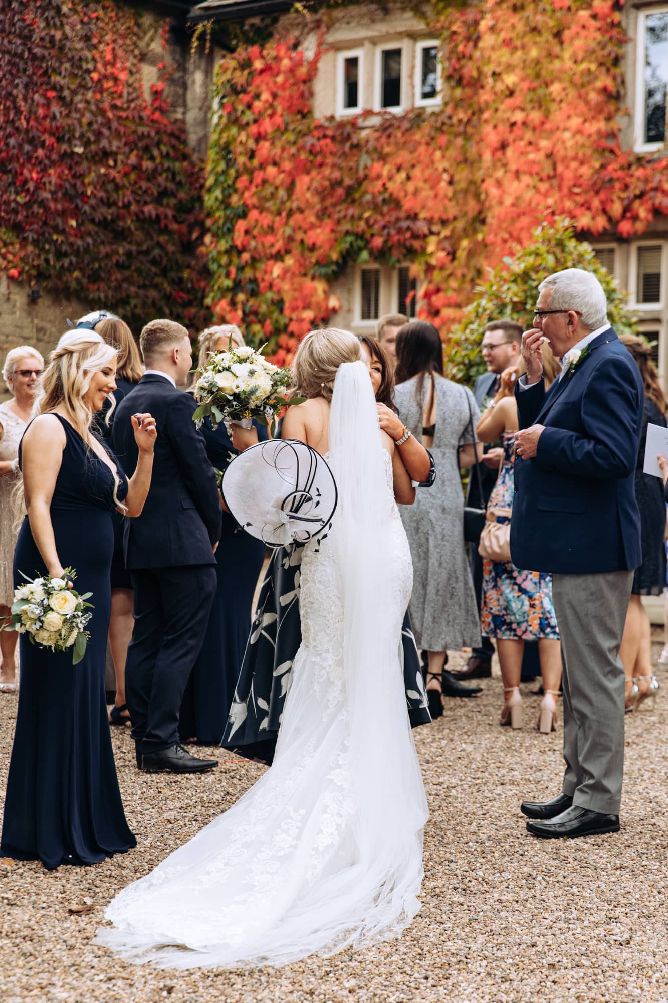 bride greeting the guests at a mitton hall wedding
