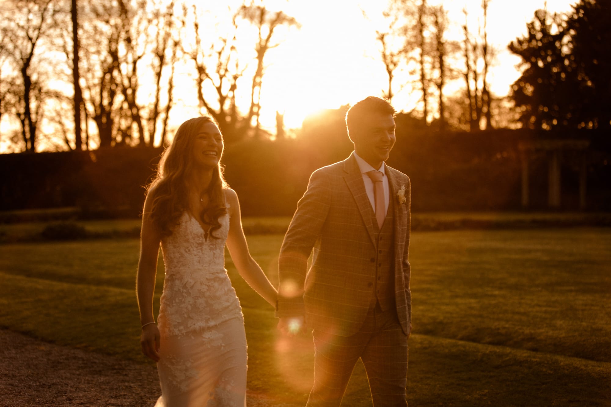 Lauren and Patrick at sunset at Eaves Hall in Cheshire. Walking through the grounds of Eaves Hall on your wedding day.