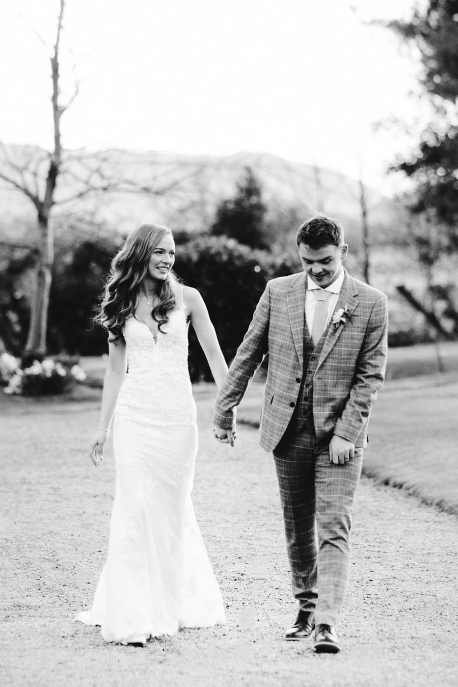 Lauren and patrick walking through the grounds of eaves hall in cheshire.