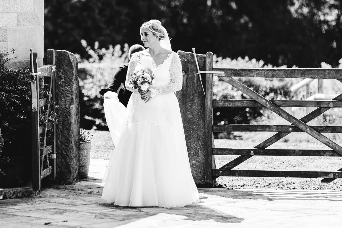 an outdoor ceremony with the bride walking down the aisle to get married at heaton house farm