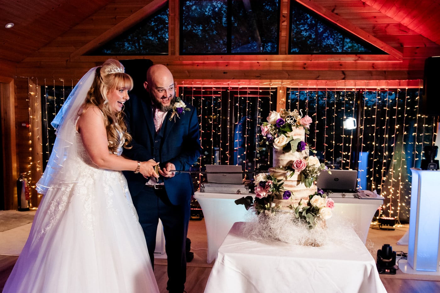 cutting the cake at styal lodge wedding venue in cheshire