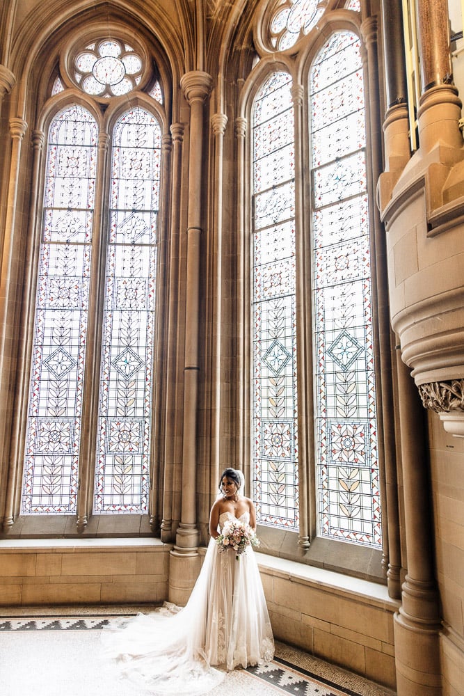 bride on the stairs at manchester university wedding chambers
