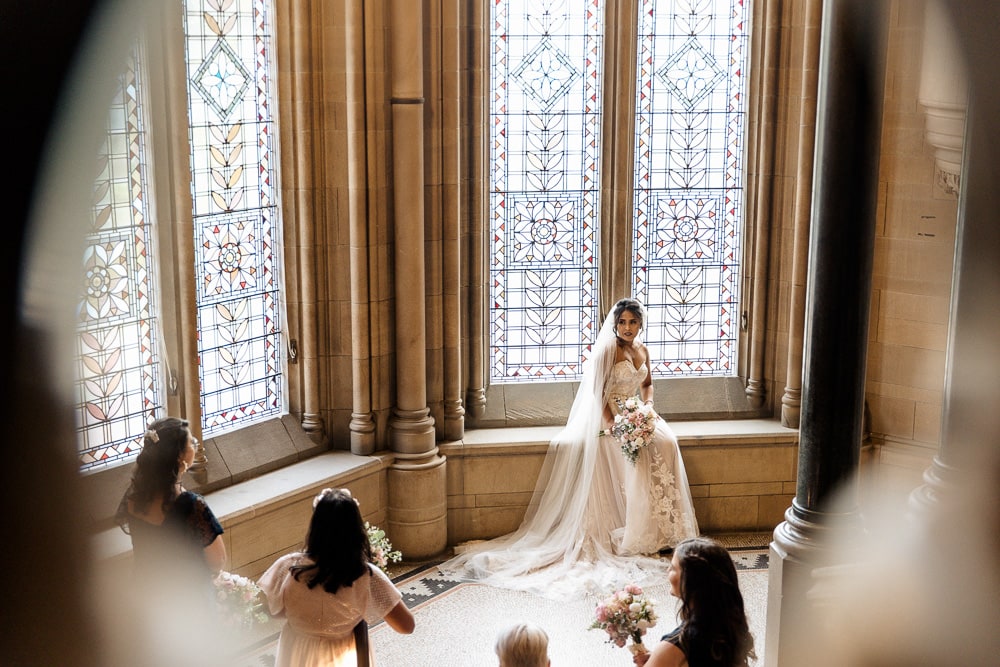 bride on the stairs at manchester university wedding chambers