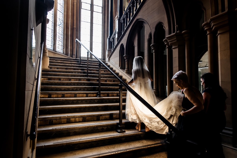 bride on the stairs at manchester university wedding chambers
