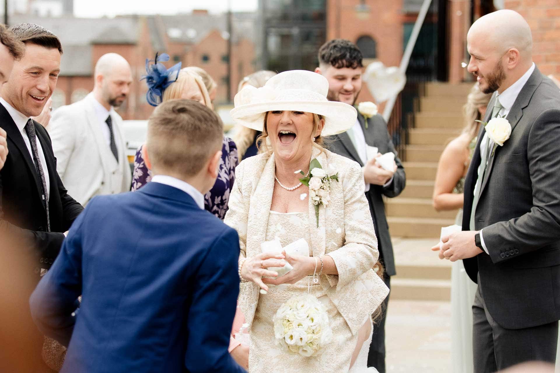 outside the castlefield rooms wedding venue guests gather for group photos