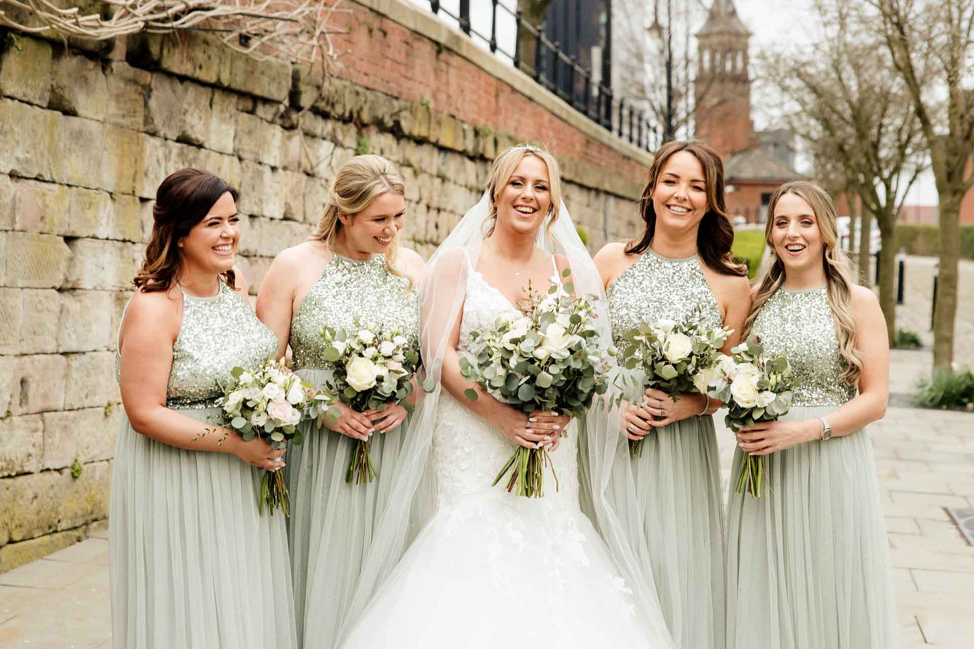 outside the castlefield rooms wedding venue guests gather for group photos