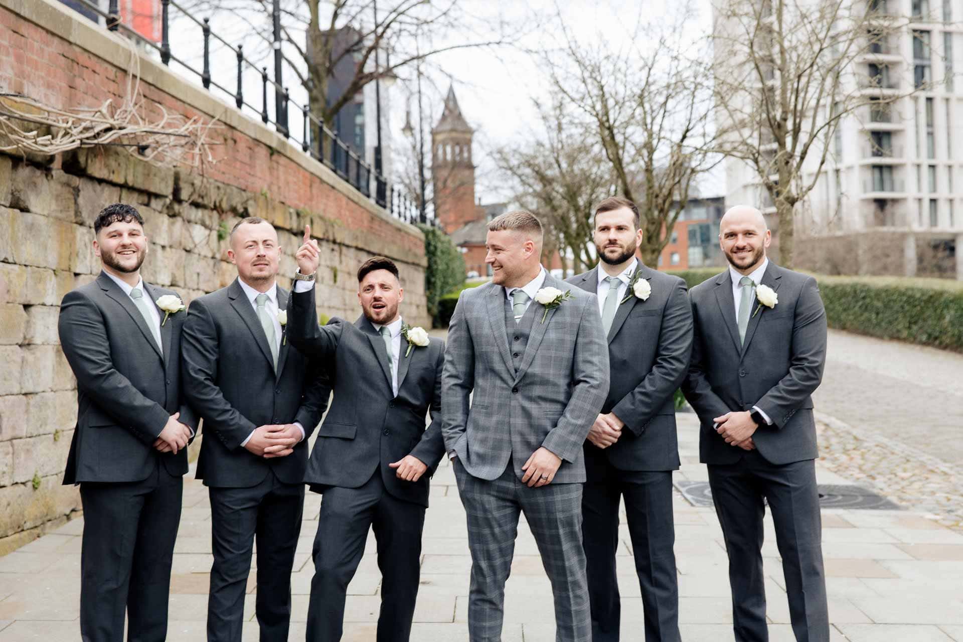 outside the castlefield rooms wedding venue guests gather for group photos
