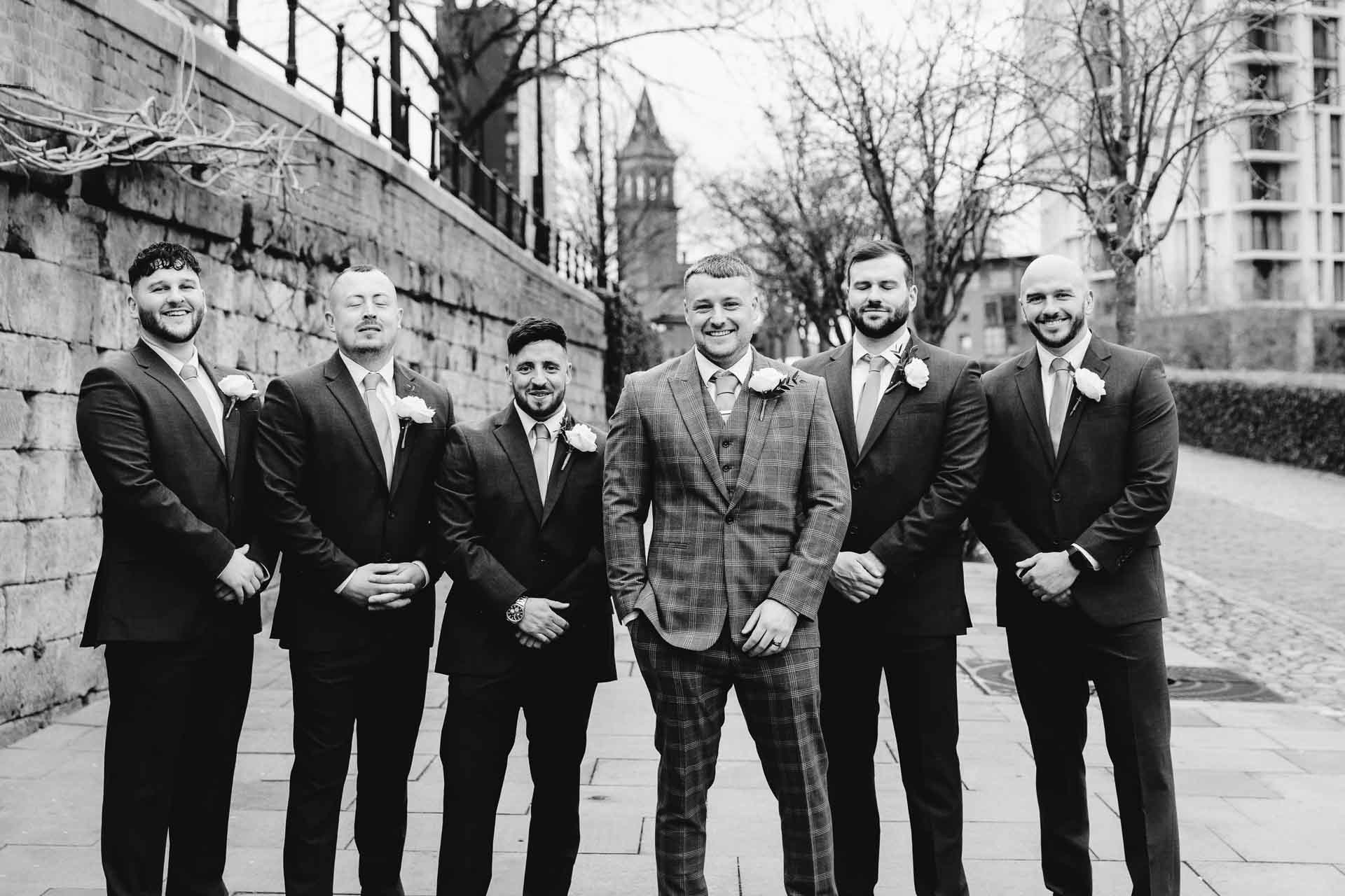 outside the castlefield rooms wedding venue guests gather for group photos