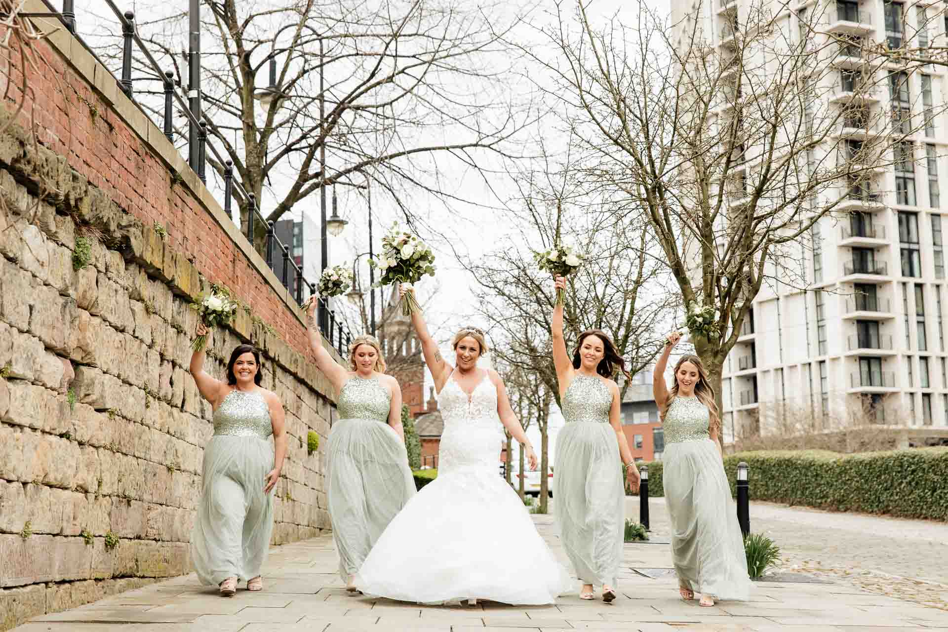 outside the castlefield rooms wedding venue guests gather for group photos