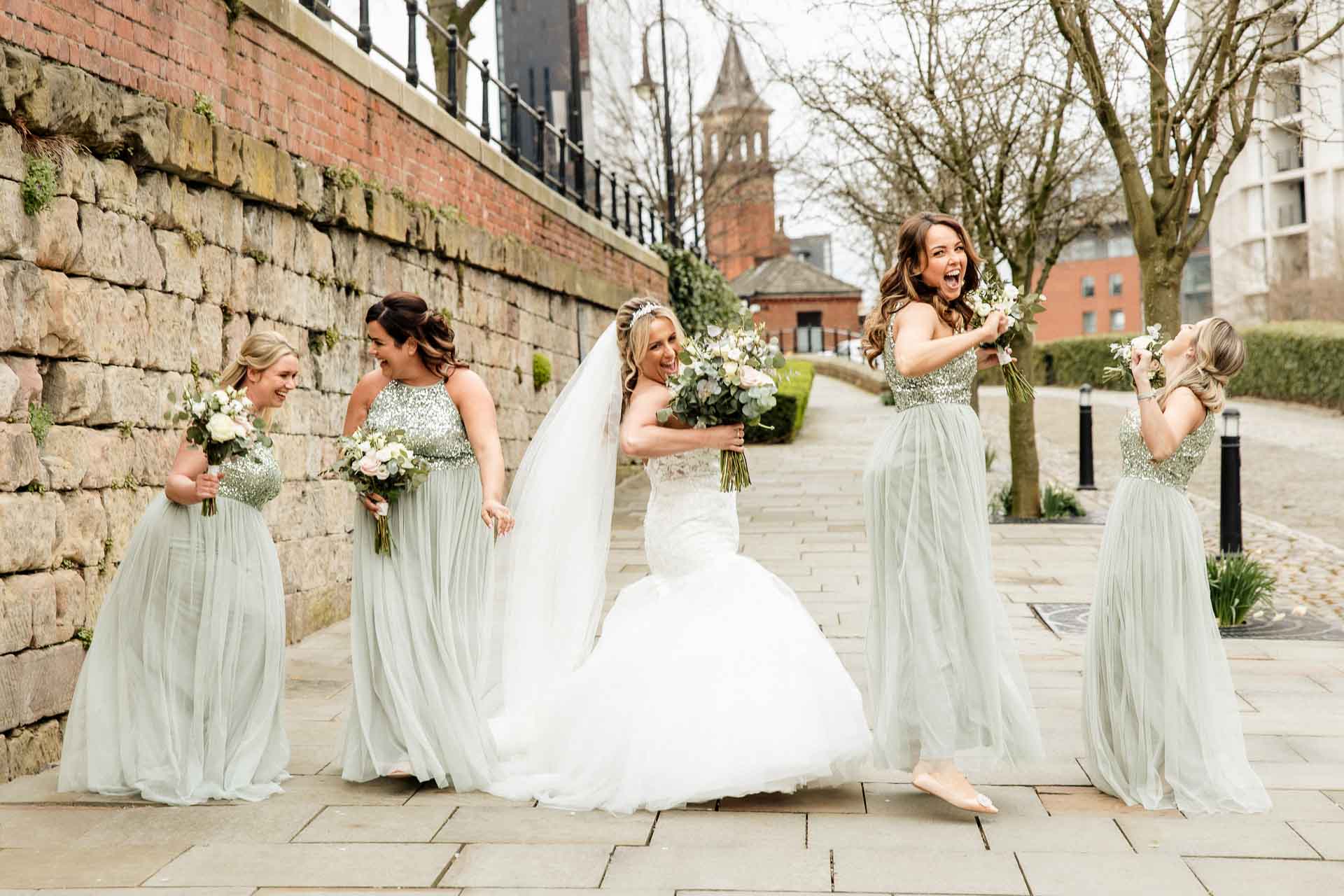 outside the castlefield rooms wedding venue guests gather for group photos