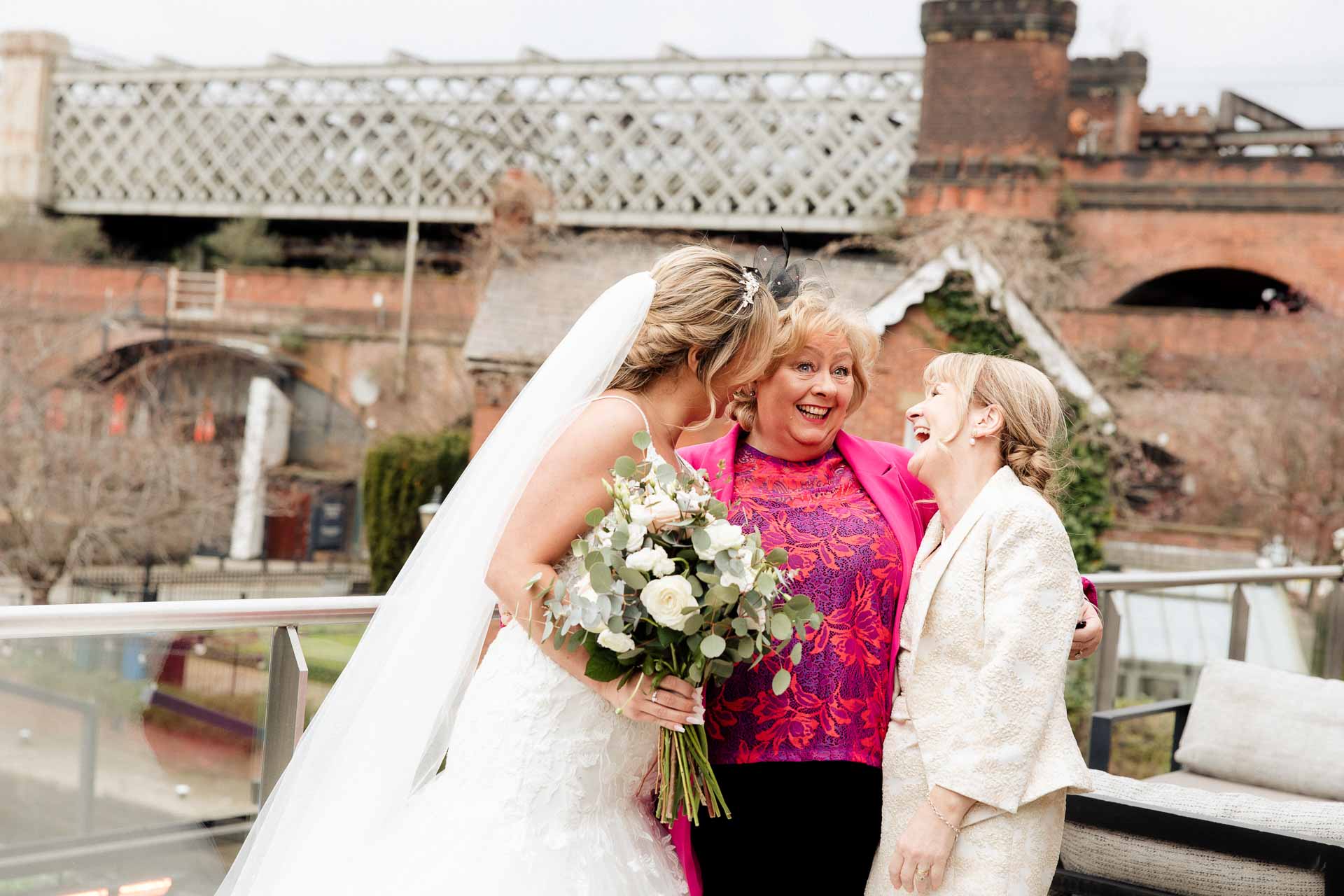 outside the castlefield rooms wedding venue guests gather for group photos