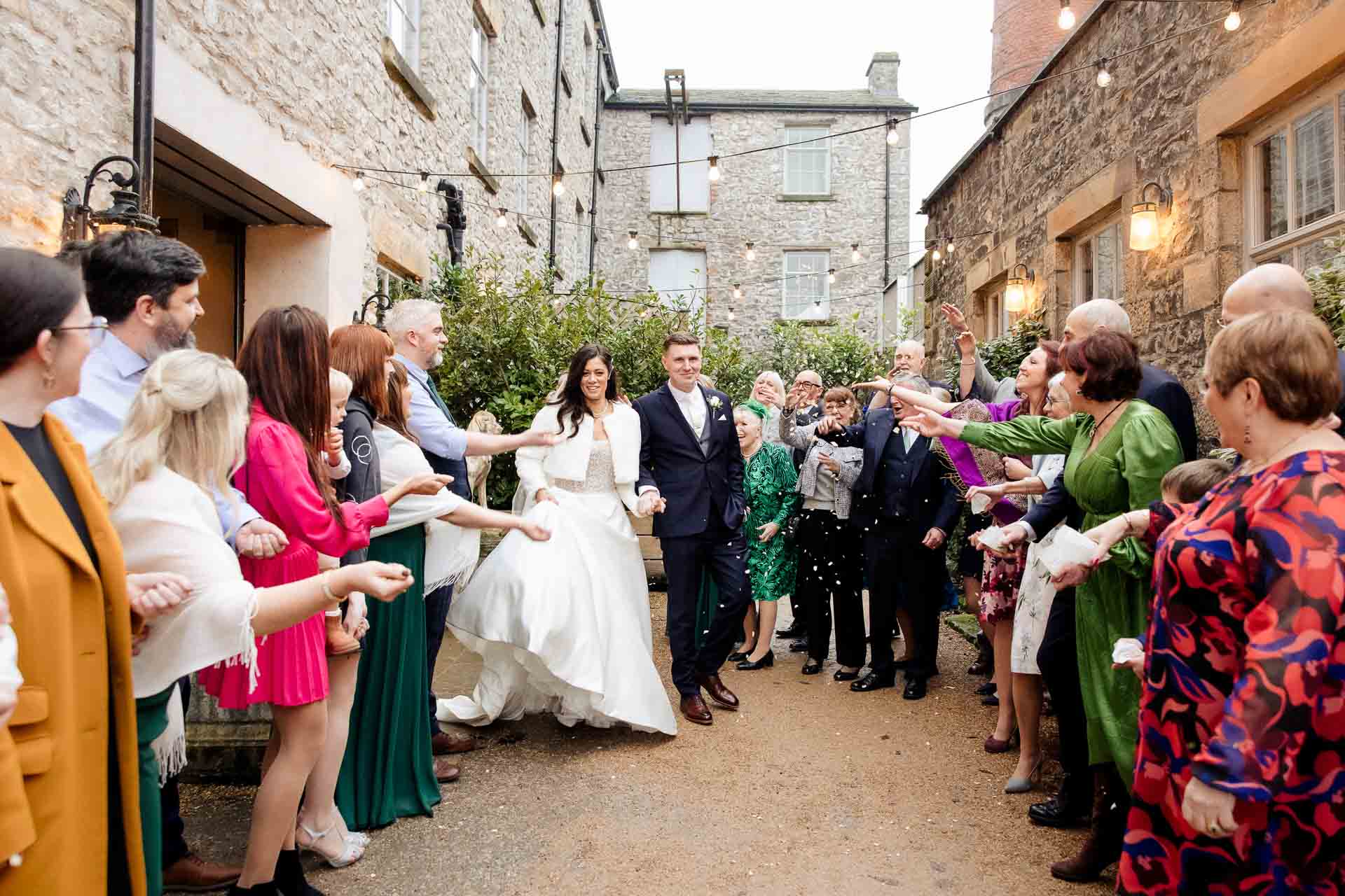 confetti with bride and groom at holmes mill