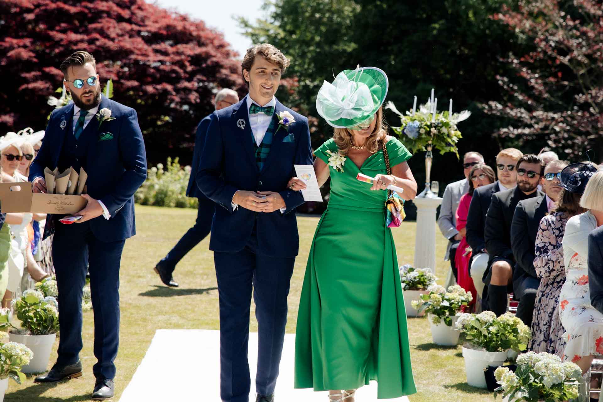 mother of the groom walking down the aisle at eaves hall