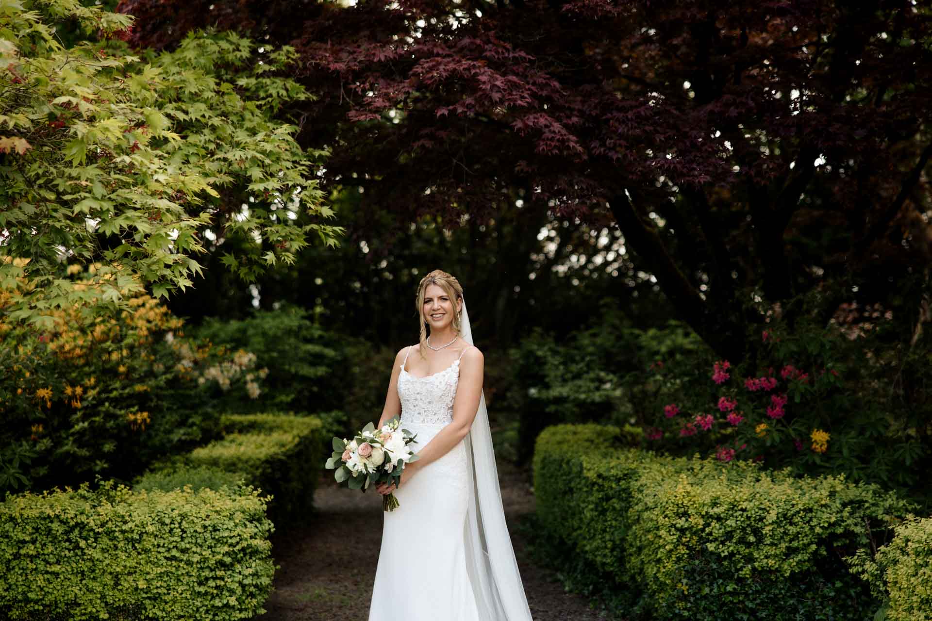 bride and groom portraits in the gardens at eaves hall lancashire